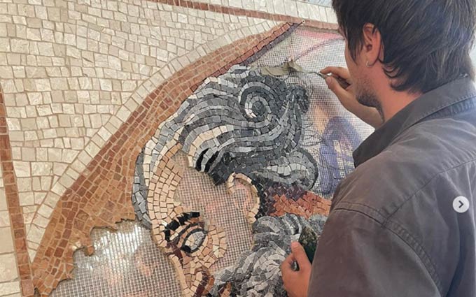 Studente della scuola di mosaico In Tesere in Italia Umbria durante la creazione di un mosaico tratto dall'iconografia della Cappella Sistina